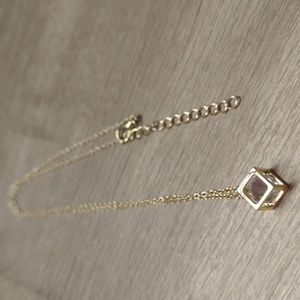 White Stone In Gold Box. Stone Moves Around. Gold Chain